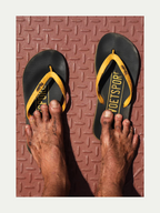 Voetspore Plakkies black and yellow flip flops close up